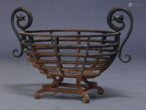 A cast iron fire basket, early 20th century, of oval pierced form, with curled twin loop handles,