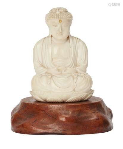 A Chinese ivory figure of Buddha, early 20th century, carved seated on a lotus base, 8cm high, on