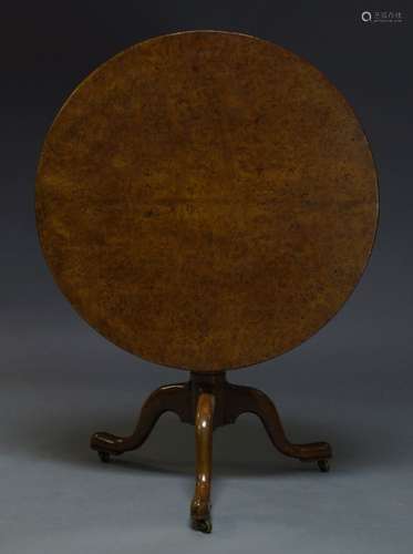 A George III pollard oak tilt top occasional table, the circular top on turned column support to