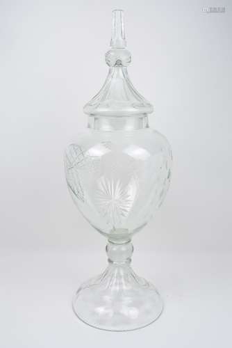 A large early 20th century glass apothecary jar of urnular form, decorated with cut glass features