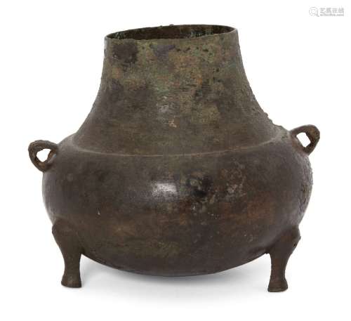 A Chinese bronze tripod vessel, Yuan dynasty, of bellied form with two lug handles to shoulder, 14cm
