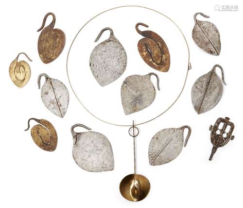 A collection of tribal interest metal pendants, to include: a white metal pendant, with stylised