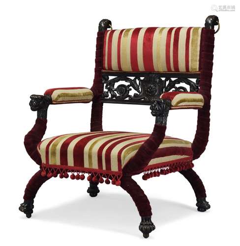 A late Victorian Savonarola chair, with carved and pierced scrolling foliate back rail,