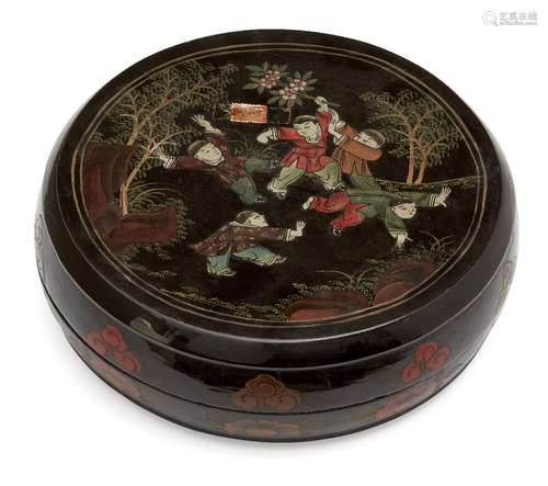 A Chinese black lacquer circular box and cover, early 20th century, painted to the cover with boys