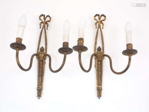 A pair of French gilt bronze two branch wall lights, with ribbon ornamentation and foliate and