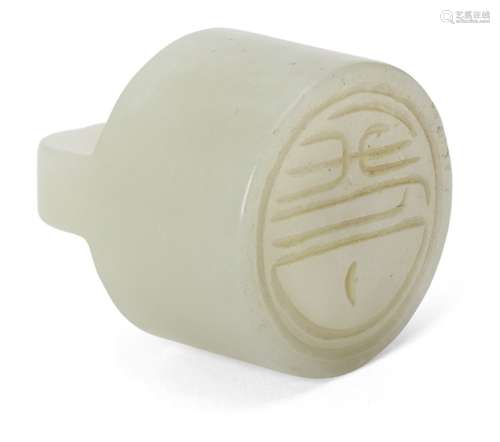 A Chinese pale green jade cylindrical seal, early 20th century, 2.8cm highA Chinese pale green