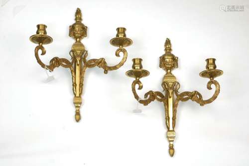 A pair of French gilt bronze two branch wall lights, early 20th century, set with ram's mask motif