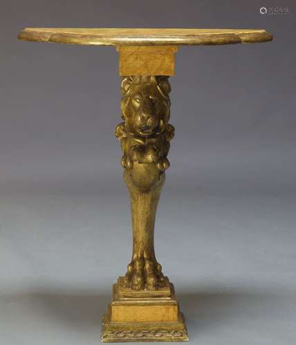 A carved giltwood console table, late 20th Century, with shaped faux marble top, above carved lion