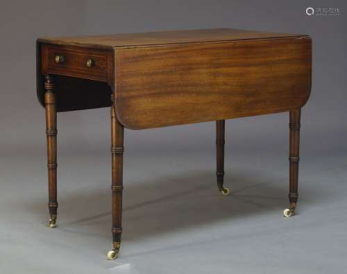 A George IV mahogany and line inlaid Pembroke table, with one frieze drawer and opposing faux