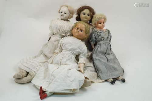 A group of three wax over composition dolls, circa. 1850-60, each in white dresses, varying