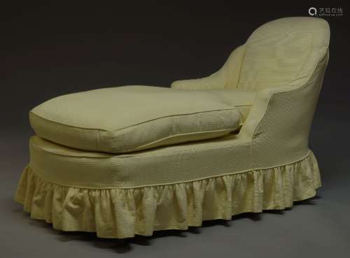 An Edwardian chaise lounge, with curved back and down swept armrests, with yellow upholstered slip