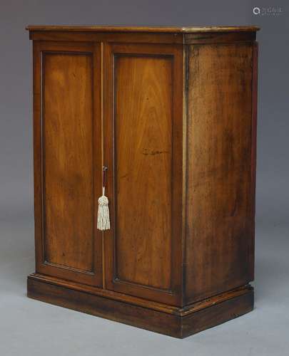 A Victorian and later mahogany cabinet, with two panelled doors enclosing one shelf, raised on