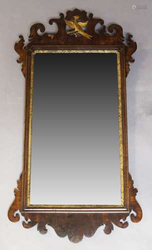 A George III mahogany and parcel-gilt fretwork mirror, with carved fretwork crest and apron, the