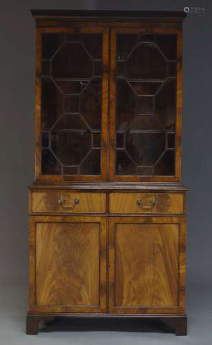 A George III style mahogany bookcase cabinet, late 20th Century, the dentil moulded cornice above