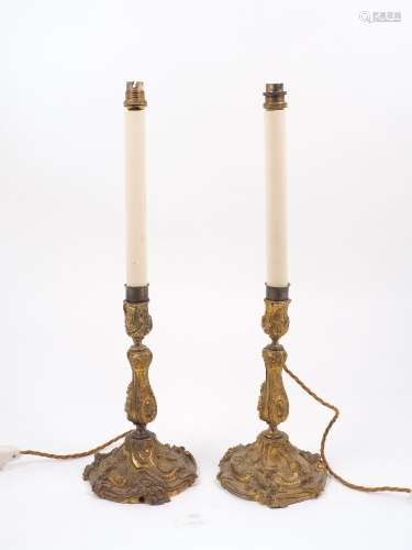 A pair of ormolu candlestick lamps, late 19th century, of inverse baluster form, the spreading