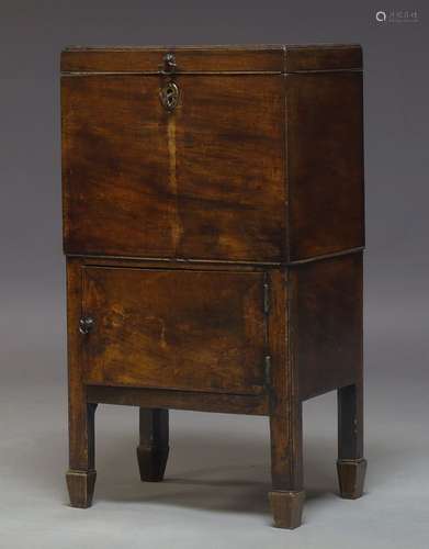 A George III mahogany decanter, the hinged lid enclosing storage space with six divisions, above