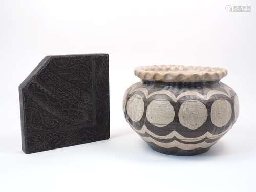 A carved ebonised wood textile printing block, 19th Century, in the form of a square with one corner