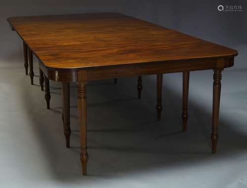 A George IV mahogany extending dining table, with two D-ends flanking central drop leaf section,