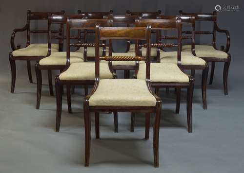 A set of ten Regency bar back dining chairs, with rope twist rails above cream upholstered drop in