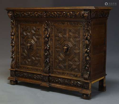 A late Victorian carved oak cabinet, the rectangular top above scrolling foliate carved frieze