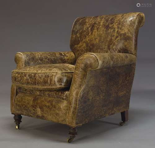 A Victorian leather armchair, upholstered in brown leather, with loose seat cushion, with front