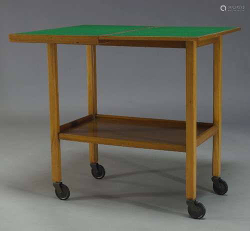 A walnut 'Chevin' trolley card table, mid 20th Century, with fold over top enclosing green baize