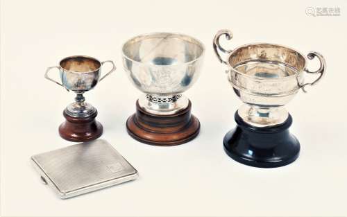 Three silver trophy cups and a silver cigarette case, the trophy cups of varying form and size,