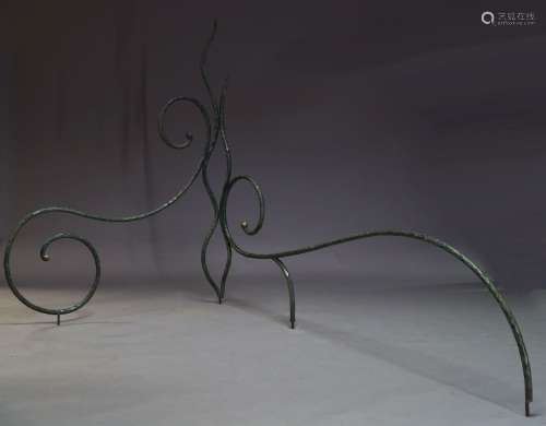 A pair of wrought iron and green painted garden sculptures, comprised of curved and scrolling iron