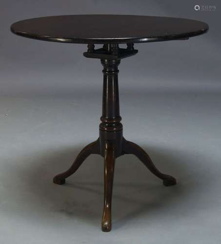 A George III and later mahogany tilt top occasional table, the circular top above birdcage action on