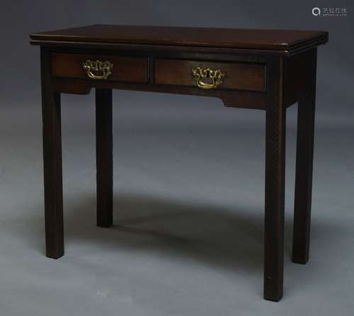 A George III mahogany tea table, the rectangular fold over top, above two frieze drawers raised on