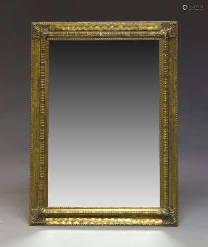 A gilt wall mirror, late 20th Century, of rectangular form, with bevelled plate set within ripple