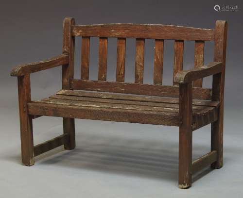 A child's garden bench, second half 20th Century, of diminutive proportions, with slatted back and