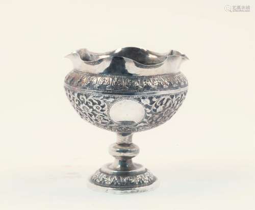 A repousse centrepiece dish, apparently unmarked, assumed Indian silver, the round body with