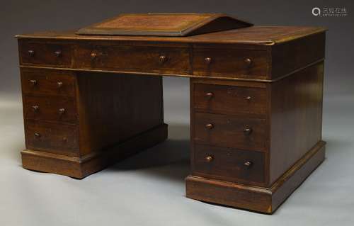 A Victorian mahogany partner's desk, the rounded rectangular top inset with brown leather writing