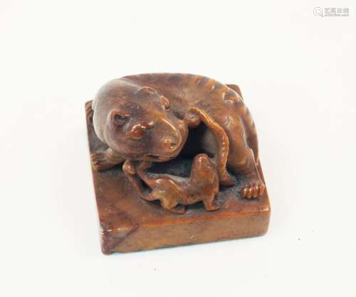 A Chinese hardstone seal, 19th century, carved as a mythical beast with cub atop a square base,