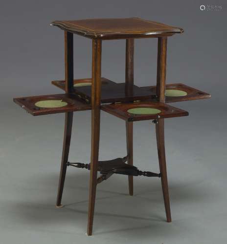 An Edwardian mahogany and crossbanded tea table, the square top of serpentine outline, over
