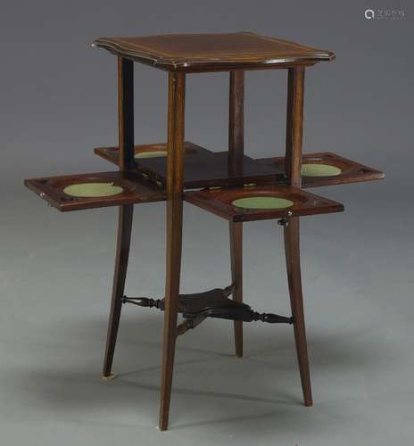 An Edwardian mahogany and crossbanded tea table, the square top of serpentine outline, over