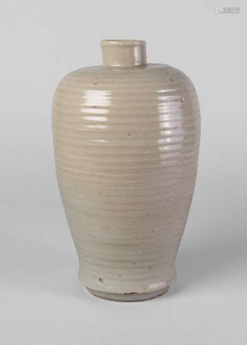 A Chinese grey stoneware ribbed vase, Song/Yuan, with thick pale celadon glaze, glazed base, 22.