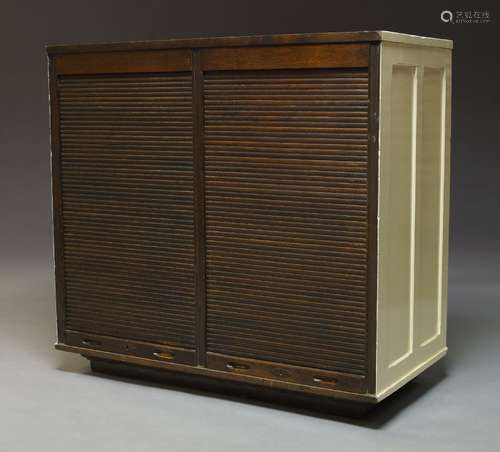 An oak double tambour fronted cabinet, early 20th Century, with white painted panelled sides and