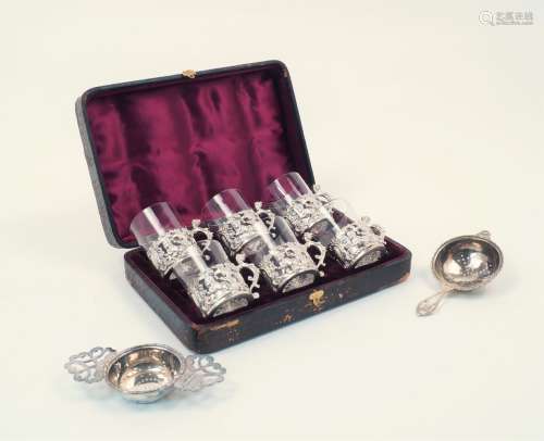 A cased set of late Victorian silver cup holders with glass inserts, London, c.1890, William Comyns,
