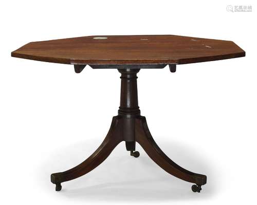 A Regency mahogany tilt top breakfast table, the octagonal top on tapering and turned column to