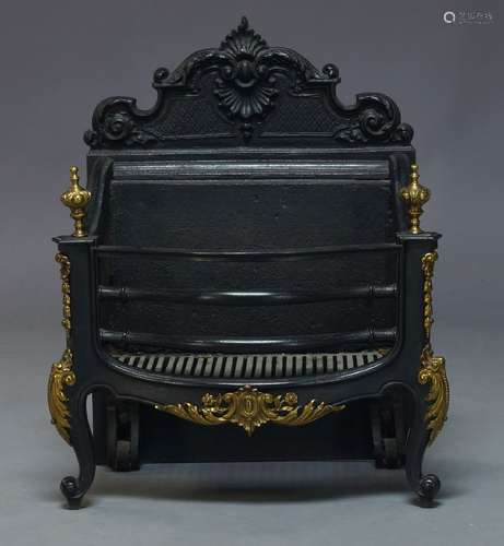 A cast iron fire grate, 20th Century, with shaped back, brass urn finials and applied gilt metal