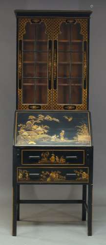 A black lacquered and Japanned bureau-bookcase, early 20th Century, the moulded cornice above two
