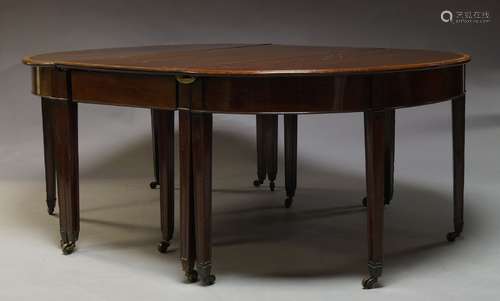 A Regency mahogany and crossbanded extending D-end dining table with two additional leaves on