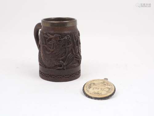 A Chinese carved wood mug, of typical cylindrical tapering form, decorated with relief of dragons,