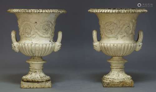 A pair of Victorian cast iron and white painted Campana urns, each with gadrooned flared rim with