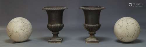 A pair of cast iron Campana urns, 20th Century, the dished top with lobed rim, on fluted lobed