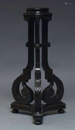 A late Victorian ebonised jardinière stand, the circular top on square acanthus carved scrolling