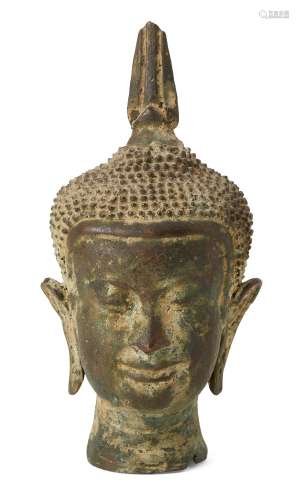 A bronze head of Buddha, possibly Thai, with characteristic long lobed ears and curled hair, eyes