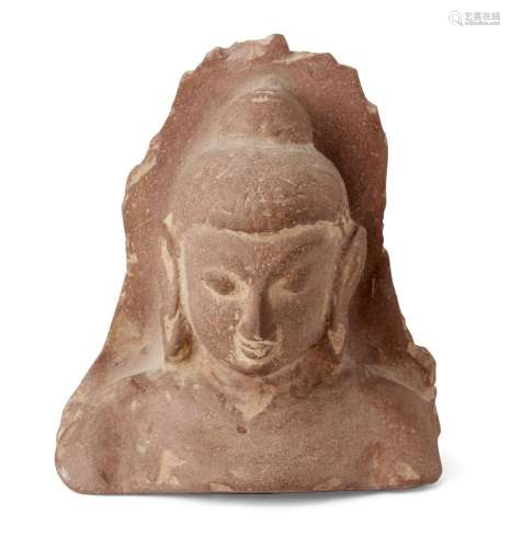 A sandstone fragmentary bust of Buddha, with characteristic long lobed ears and hair pulled to a top